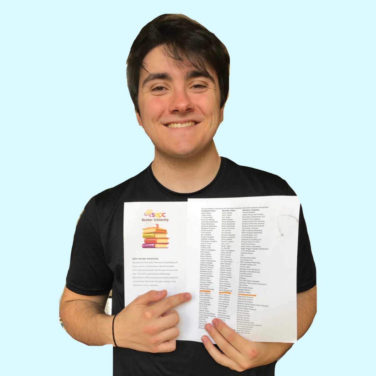 Jacob, a high school senior, holding a scholarship award letter